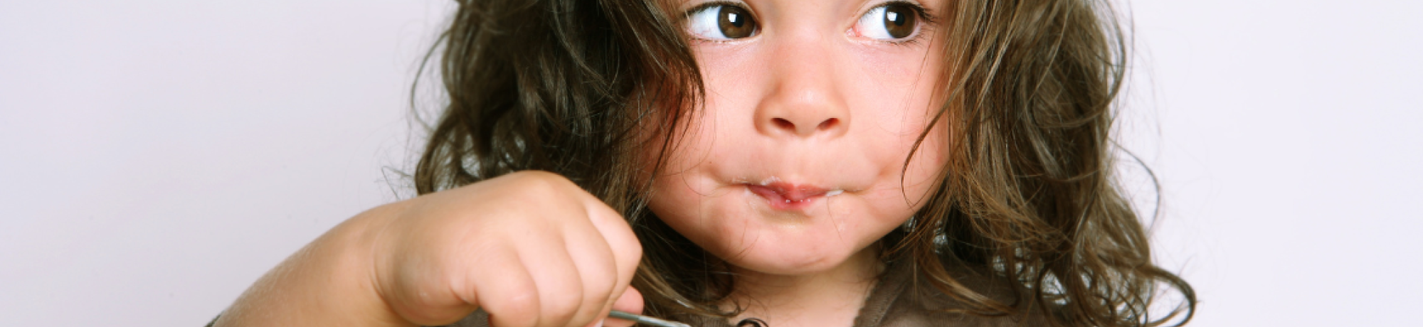 Toddler girl eating yogurt